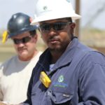 Workers take in a safety briefing at Devon Energy's Todd 2 water recycling facility,