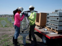 FILE PHOTO: Construction workers Tekovin Miller and Darien Bailey install actuators for tilting panels at the Duette solar site which is being developed on previously agricultural land in Bowling Green, Florida, U.S., March 24, 2021. Picture taken March 24, 2021. REUTERS/Dane Rhys/File Photo